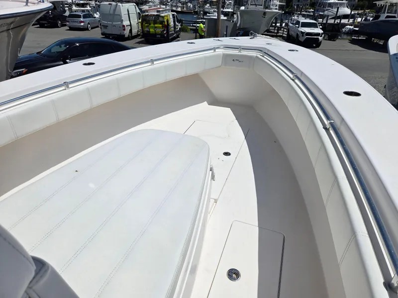 Slide: The Image of 2016 Contender 32 ST boat interior with white seating and spacious deck. - 21