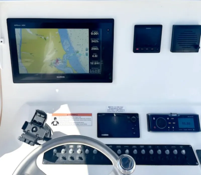Slide: The Image of Dashboard of a 2016 Contender 32 ST boat with navigation and control systems. - 3