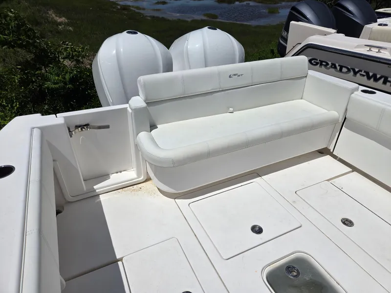 Slide: The Image of 2016 Contender 32 ST boat interior with white seating and storage compartments. - 5