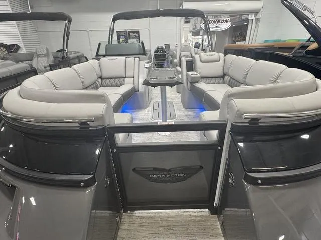 Slide: The Image of 2025 Bennington Q Quad Bench 25 QFB pontoon boat with luxurious seating and modern design. - 14