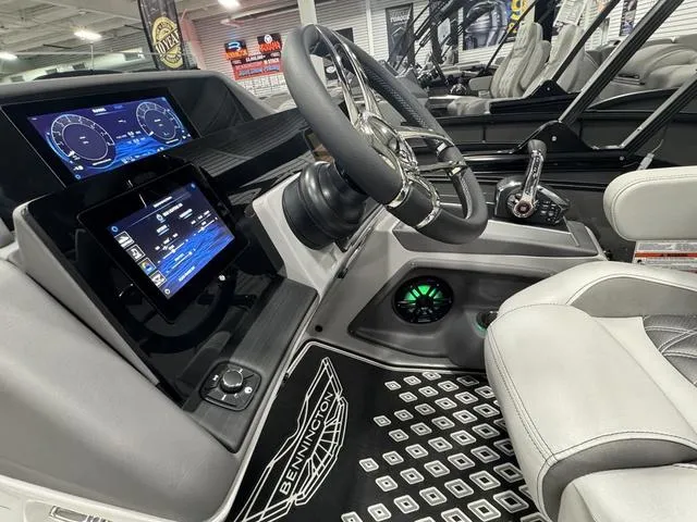 Slide: The Image of 2025 Bennington Q Quad Bench 25 QFB boat interior with modern dashboard and steering wheel. - 16