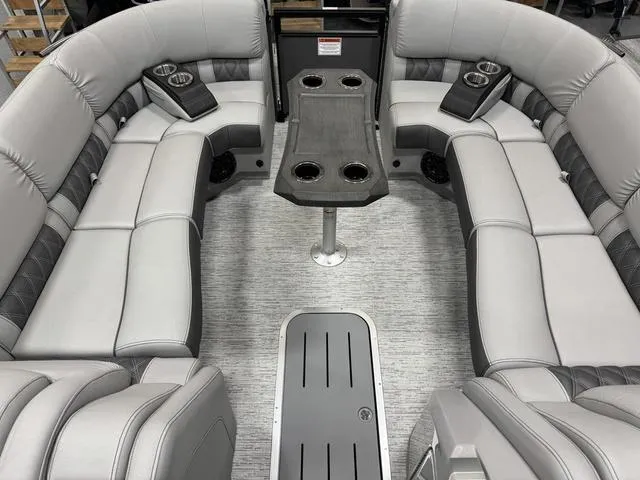 Slide: The Image of 2025 Bennington Q Quad Bench 25 QFB interior with gray seating and cup holders. - 20