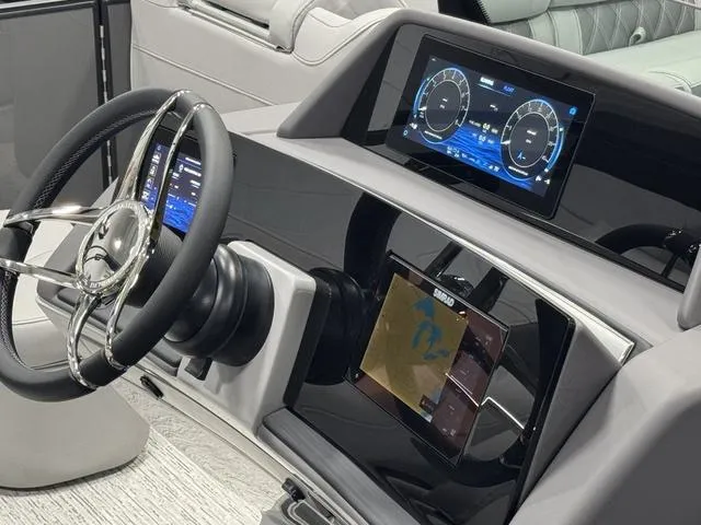 Slide: The Image of 2025 Bennington Q Quad Bench 25 QFB dashboard with digital displays and steering wheel. - 22