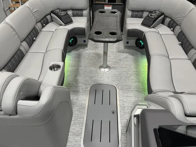 Slide: The Image of Luxurious seating on 2025 Bennington Q Quad Bench 25 QFB with ambient lighting and cup holders. - 25