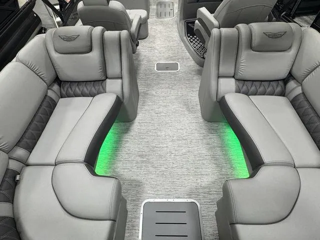 Slide: The Image of Luxurious interior of 2025 Bennington Q Quad Bench 25 QFB with gray seating and green lighting. - 26