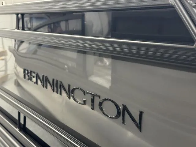 Slide: The Image of 2025 Bennington Q Quad Bench 25 QFB boat, close-up of logo and sleek design. - 27
