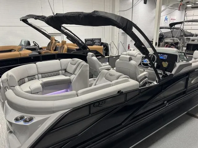 Slide: The Image of 2025 Bennington Q Quad Bench 25 QFB pontoon boat with luxurious seating and modern design. - 29