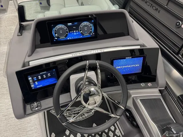 Slide: The Image of 2025 Bennington Q Quad Bench 25 QFB dashboard with modern digital displays and steering wheel. - 3