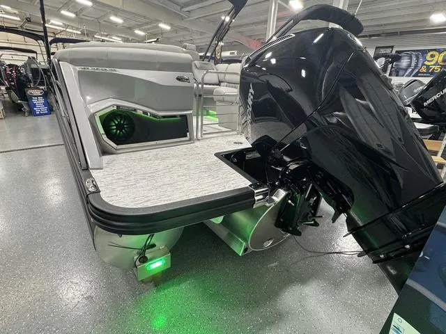 Slide: The Image of 2025 Bennington Q Quad Bench 25 QFB pontoon boat with powerful outboard motor in showroom. - 33