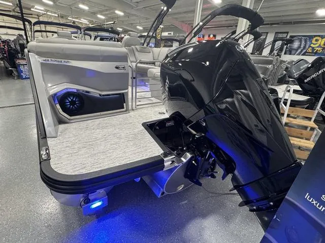 Slide: The Image of 2025 Bennington Q Quad Bench 25 QFB boat with powerful outboard motor in showroom. - 34