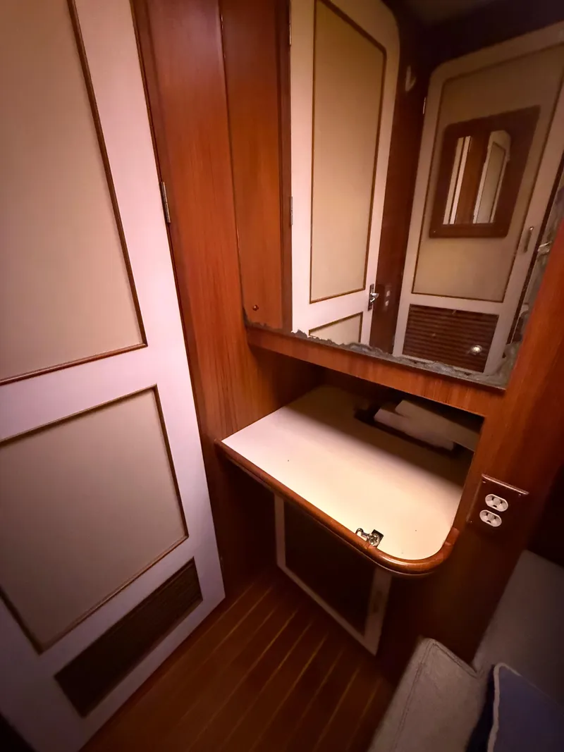 Slide: The Image of 1988 Hi-Star 44 Convertible interior with wooden cabinetry and mirror. - 10