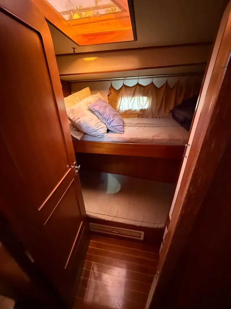 Slide: The Image of Cozy cabin interior of 1988 Hi-Star 44 Convertible yacht with wooden finishes and bedding. - 13