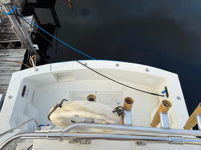 Slide: The Image of 1988 Hi-Star 44 Convertible boat deck with railing and fishing rod holders. - 3