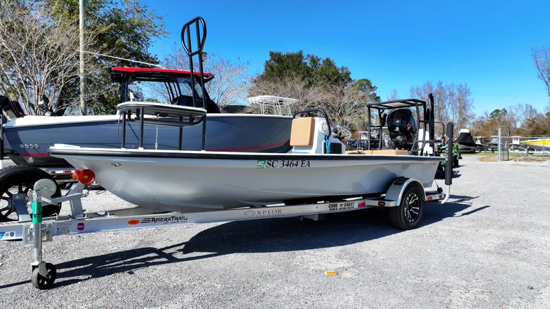 Slide: The Image of 2022 Xplor X7 boat on trailer in outdoor setting, clear blue sky. - 1