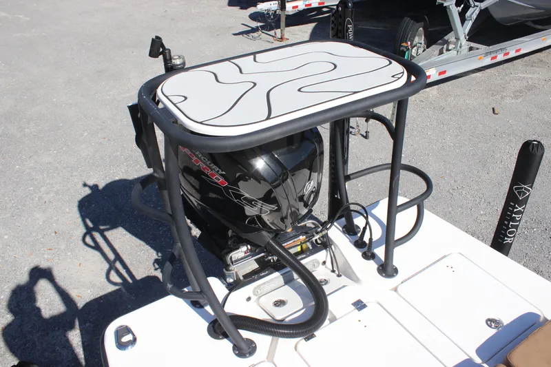 Slide: The Image of 2022 Xplor X7 boat engine with protective frame and platform, parked on gravel. - 4