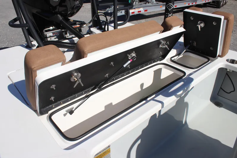 Slide: The Image of Open storage compartment on 2022 Xplor X7 boat with brown seating. - 5