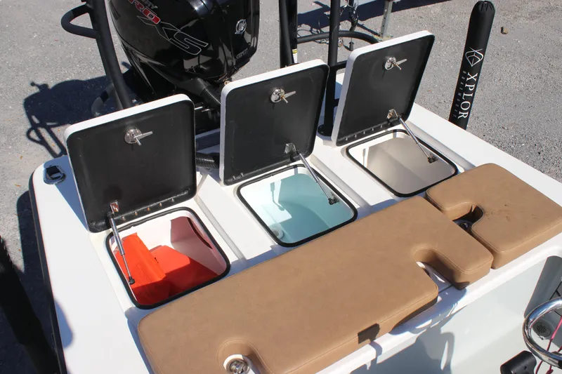 Slide: The Image of Xplor X7 2022 boat storage compartments with open lids, showcasing organized interior spaces. - 7