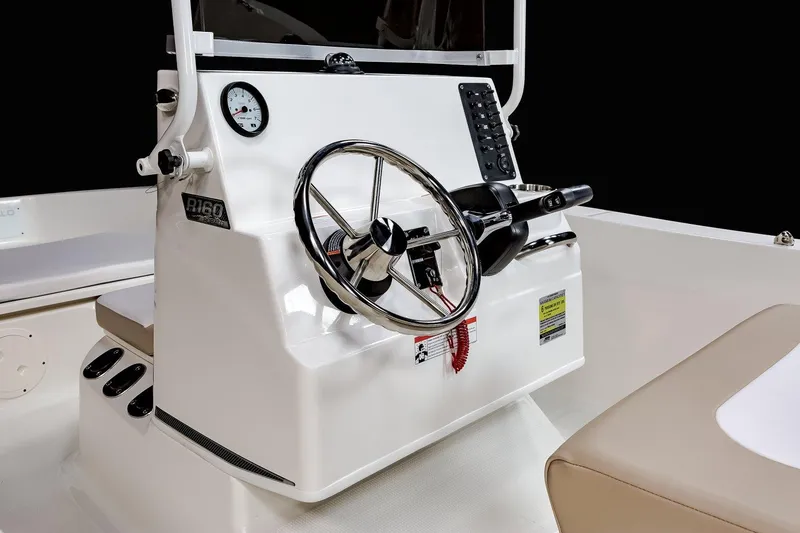 Slide: The Image of 2025 Robalo R160 Center Console boat steering wheel and dashboard. - 11