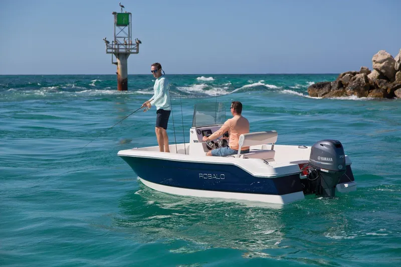 Slide: The Image of 2025 Robalo R160 Center Console boat on water, two people fishing near a marker. - 14