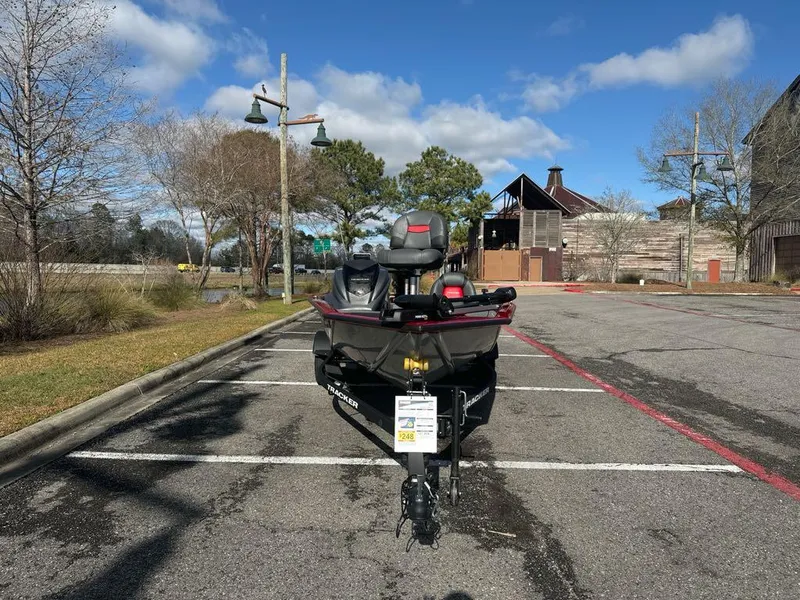 Slide: The Image of 2025 Tracker Pro Team 175 boat parked in an empty lot under a clear blue sky. - 3