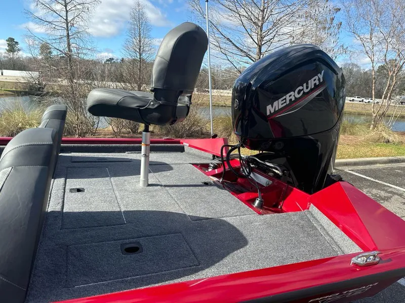 Slide: The Image of 2025 Tracker Pro Team 175 boat with Mercury engine, red deck, and fishing seat. - 6