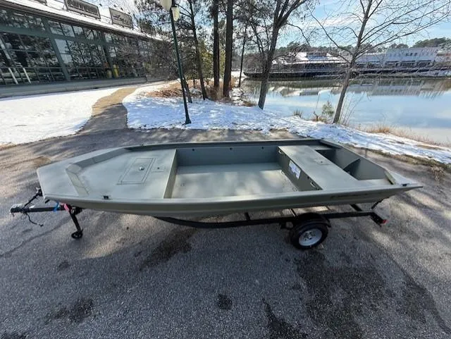 Slide: The Image of 2025 Tracker Grizzly 1648 Jon boat on trailer by a snowy lakeside. - 14