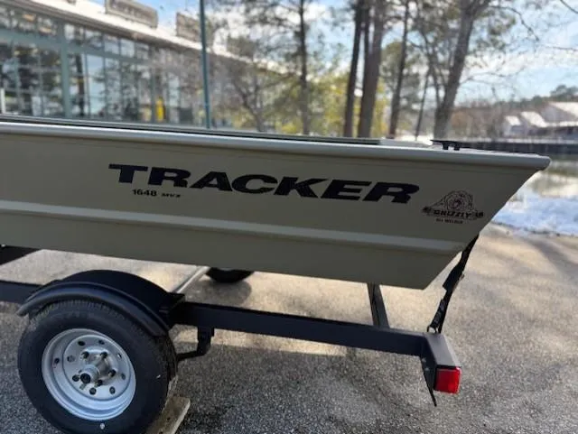 Slide: The Image of 2025 Tracker Grizzly 1648 Jon boat on trailer, parked outdoors. - 16