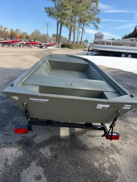 Slide: The Image of 2025 Tracker Grizzly 1648 Jon boat on trailer, parked outdoors. - 17