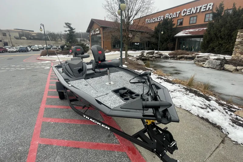 Slide: The Image of 2025 Tracker Pro Team 175 boat displayed outside Tracker Boat Center in winter setting. - 2