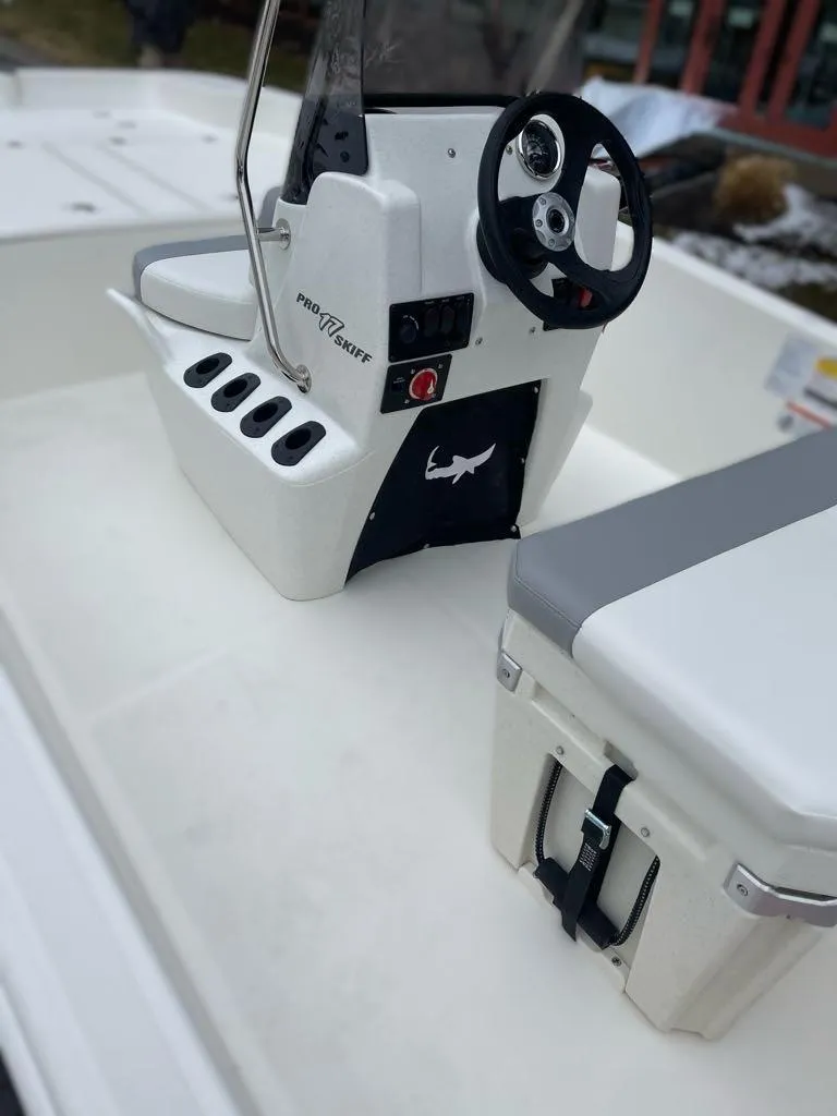 Slide: The Image of 2025 Mako Pro Skiff 17 CC boat interior with steering console and seating. - 6