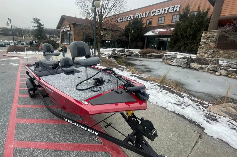 Slide: The Image of 2025 Tracker Pro 170 boat displayed outside Tracker Boat Center in winter setting. - 2