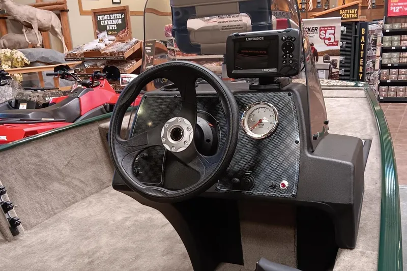 Slide: The Image of 2025 Tracker Bass Tracker Classic Limited boat dashboard with steering wheel and navigation system. - 3