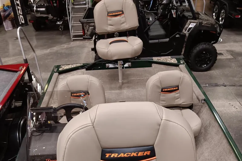Slide: The Image of 2025 Tracker Bass Tracker Classic Limited boat interior with beige seats in a showroom. - 4