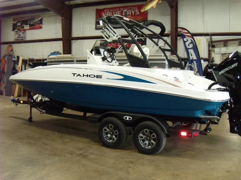 The Image of 2025 Tahoe 2150 CC boat on trailer in indoor showroom. - 0
