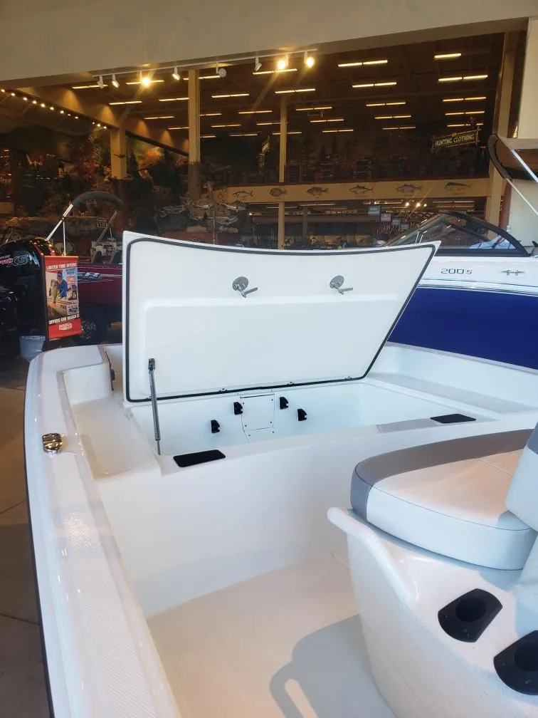 Slide: The Image of 2025 Mako Pro Skiff 15 CC boat interior with open storage compartment in showroom. - 6