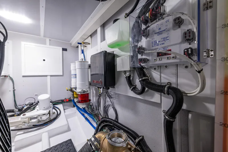 Slide: The Image of Engine room of a 2026 Northwest 58 yacht, showcasing advanced mechanical systems and wiring. - 11