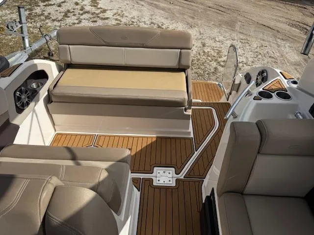 Slide: The Image of 2014 Regal 28 Express boat interior with beige seating and wood-style flooring. - 10