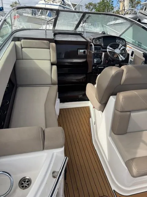 Slide: The Image of 2014 Regal 28 Express boat interior with seating and steering console. - 12