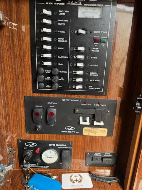 Slide: The Image of Control panel of a 2014 Regal 28 Express boat with various switches and gauges. - 21