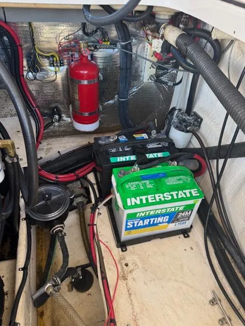 Slide: The Image of Engine compartment of a 2014 Regal 28 Express with Interstate battery and fire extinguisher. - 26