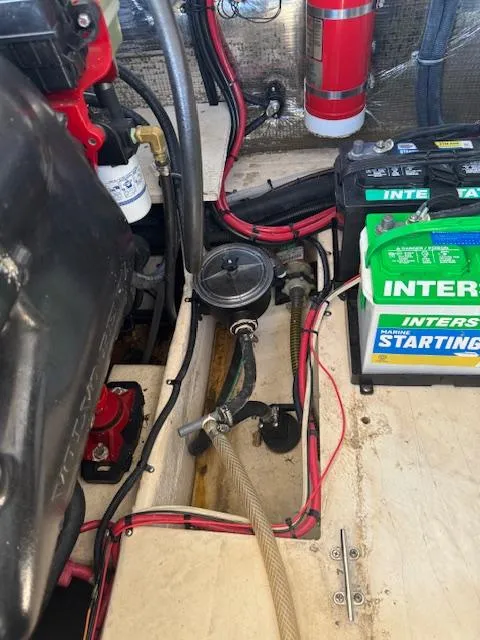 Slide: The Image of Engine compartment of a 2014 Regal 28 Express boat with battery and fire extinguisher. - 28