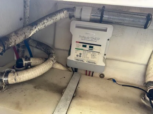 Slide: The Image of 2014 Regal 28 Express boat interior showing ProNautic 1240P charger and plumbing components. - 30