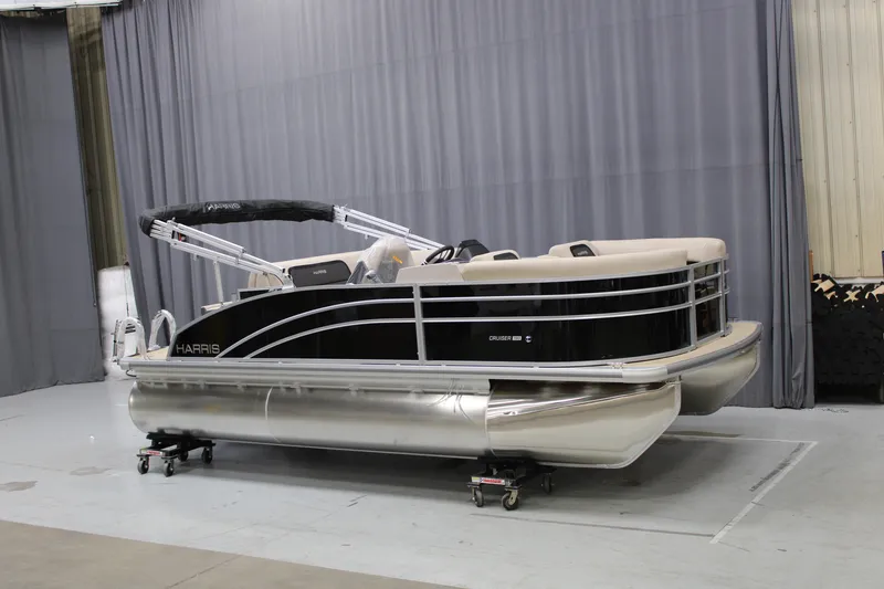Slide: The Image of 2025 Harris Cruiser 190 pontoon boat in a showroom setting. - 7