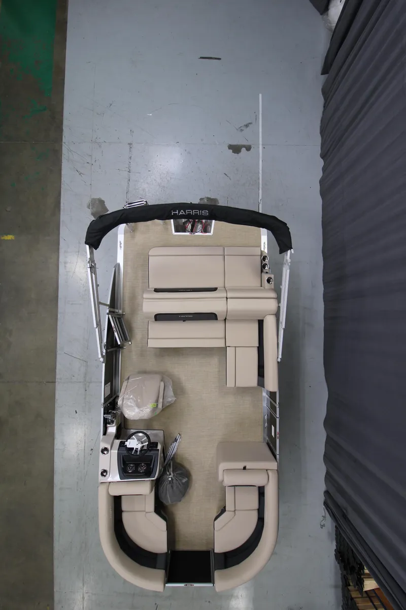 Slide: The Image of 2025 Harris Cruiser 190 pontoon boat, aerial view, showcasing seating and helm layout. - 8