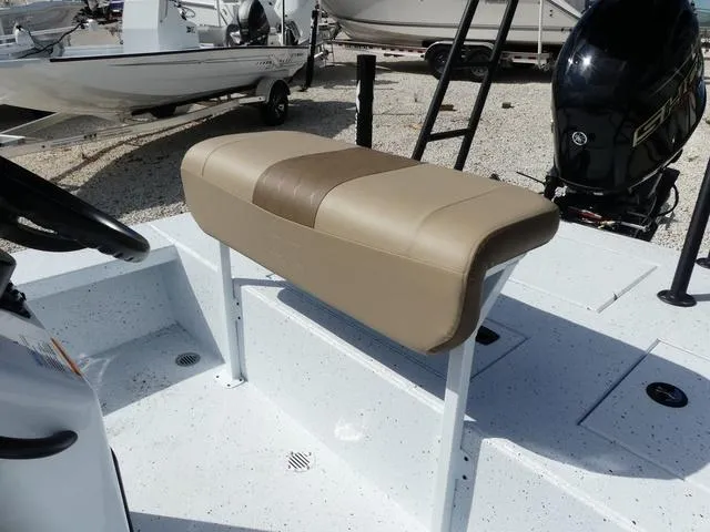 Slide: The Image of 2025 Xpress Boats Skiff 185, beige seating, white deck, outdoor display. - 10