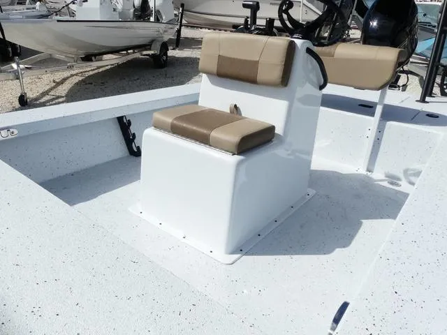 Slide: The Image of 2025 Xpress Boats Skiff 185 with beige seating, white deck, and center console. - 11