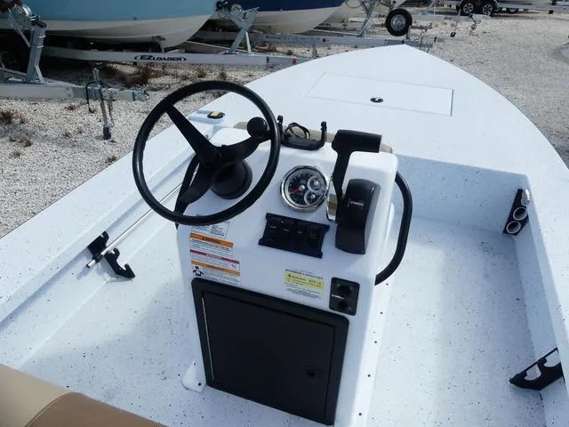 Slide: The Image of 2025 Xpress Boats Skiff 185 console with steering wheel and controls. - 16