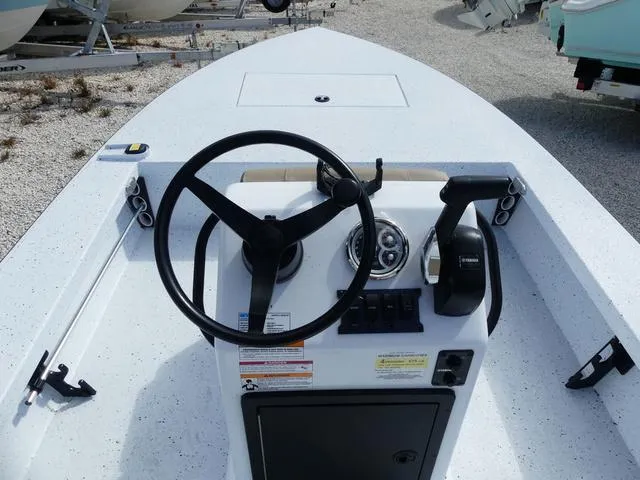 Slide: The Image of 2025 Xpress Boats Skiff 185 console with steering wheel and controls. - 17