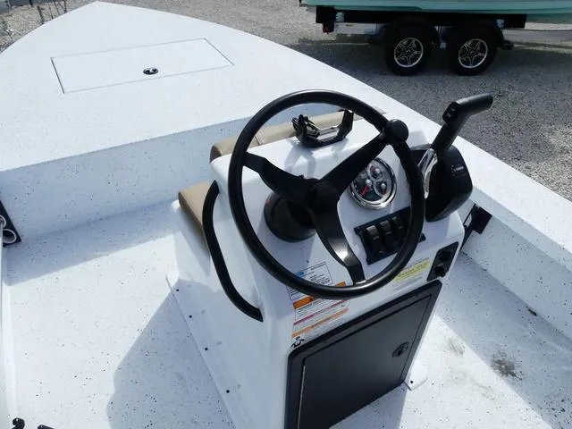 Slide: The Image of 2025 Xpress Boats Skiff 185 steering console with controls and gauges. - 18