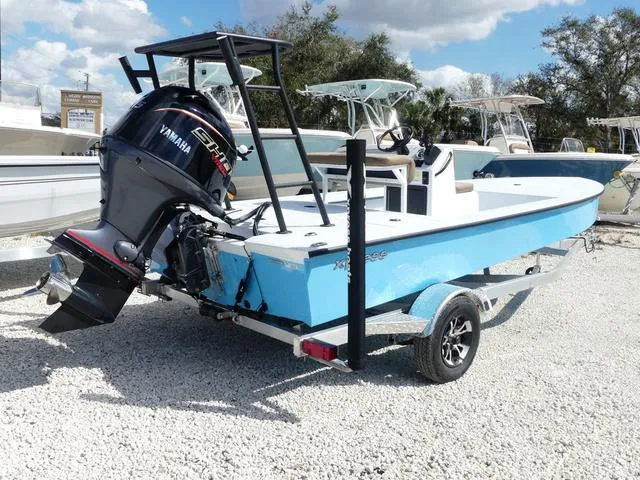 Slide: The Image of 2025 Xpress Boats Skiff 185 with Yamaha engine on trailer, parked outdoors. - 5